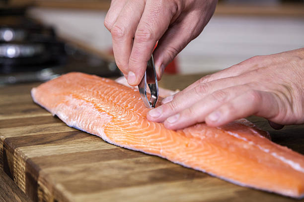 istock Close up of removing fish bone from salmon. 629639016