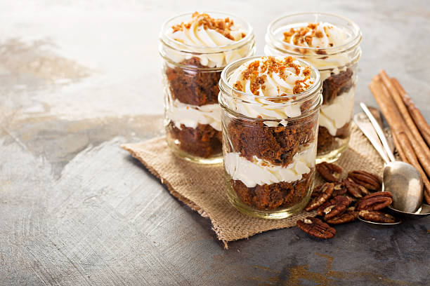 Carrot cake in a jar Carrot cake in a jar with pecan nuts and cinnamon cake jar stock pictures, royalty-free photos & images