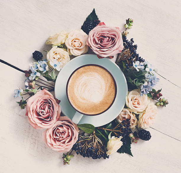 istock Cappuccino coffee and flowers composition on white wood 629641452