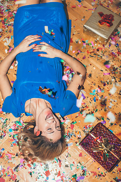 Party Girl laying on the floor full of confetti 3686 stock pictures, royalty-free photos & images