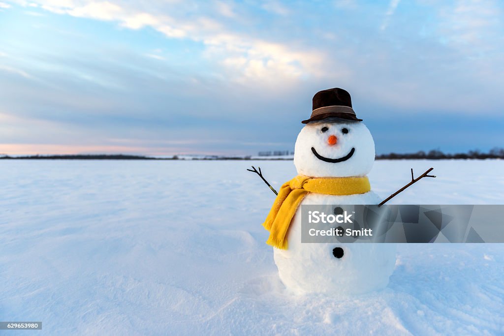 snowman snowman on orange sunset background Snowman Stock Photo