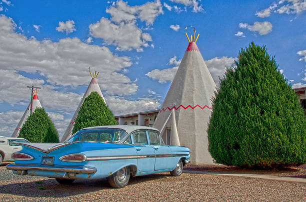 Wigwam Motel on Route 66 Holbrook, United States - September 3, 2016: The Wigwam Motel on Route 66 in Holbrook, Arizona is one of seven built by Chester E. Lewis from plans used originally to create 3 wigwam villages in Kentucky. Holbrook's motel is one of two that is still operational along Route 66. The tee pees are constructed out of concrete and each has a vintage car parked in front. The business is still fully operational, with the cost of a one night stay approximately $55. roadside motel stock pictures, royalty-free photos & images