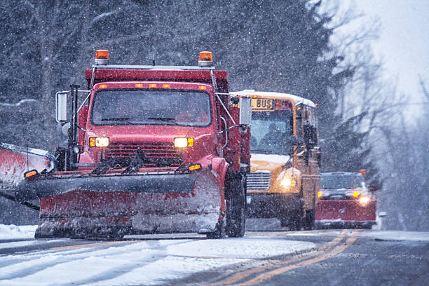 istock School Bus And Two Snowplow Trucks During Blizzard Snow Storm 629655342