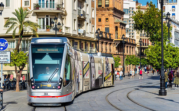 трамвай metrocentro на авенида-де-ла-конституция в севилье, испания - train spain seville europe стоковые фото и изображения