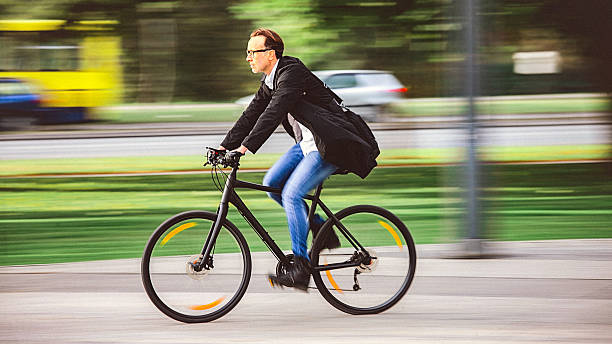 istock Handsome man riding bicycle on the way to work 629664700