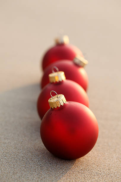 istock Red Christmas Ornaments on the Beach 629665768