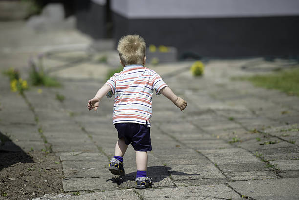 istock Baby boy running at home backyard 629666520