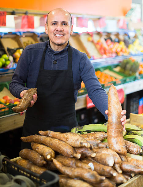 istock Seller with cassava roots at market 629666834