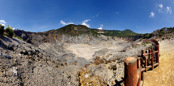 Panoramic view of Tangkuban Perahu crater, showing beautiful and huge mountain crater, at the morning,illuminated by sunlight. There also a blue sky and beautiful cloud