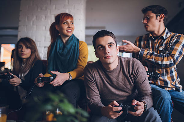 istock Colleagues playing video games in the office relax room 629676918