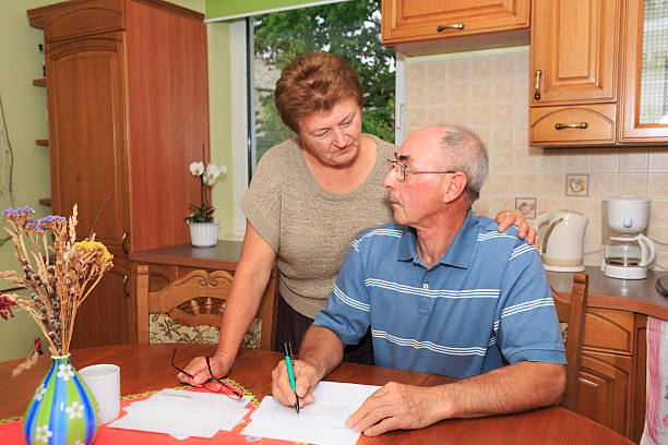 istock Senior couple going over bills 629680316