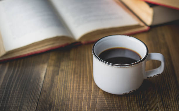 istock coffee in old cup on wooden with the book 629680648