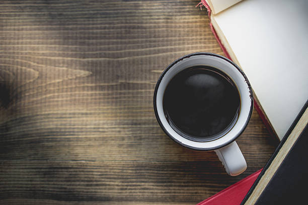 istock coffee in old cup on wooden with the book 629680690