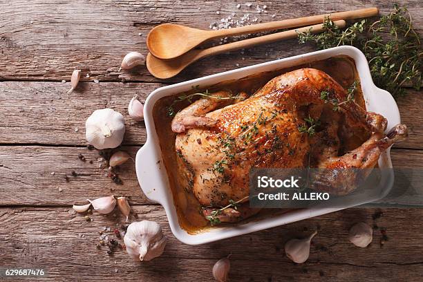 French Food Chicken With 40 Cloves Of Garlic Stock Photo - Download Image Now - Chicken Meat, Baked, Christmas