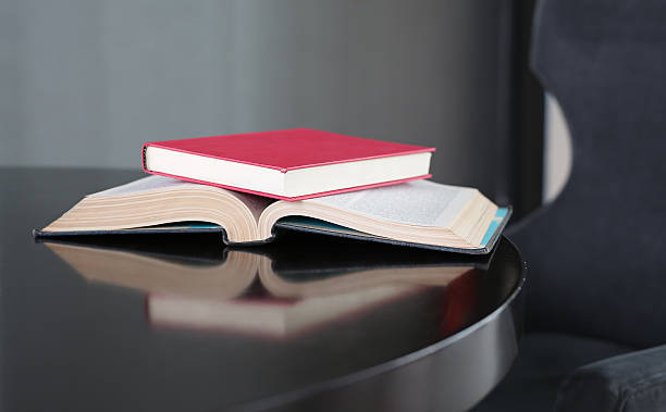 istock Open book, hardback books on wooden table. Education background. 629687914