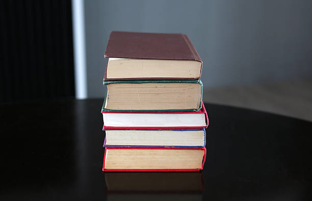 istock stack of hardcover books on wooden table 629689368