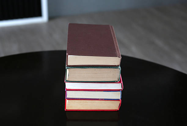 istock stack of hardcover books on wooden table 629689390