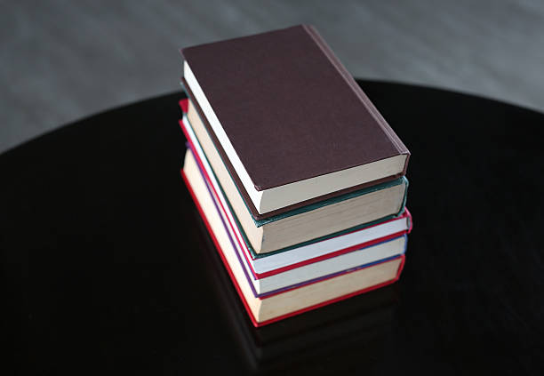 istock stack of hardcover books on wooden table 629689428