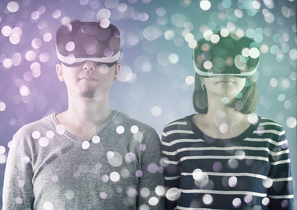 Couple using virtual reality headset Couple with a head mounted display head mounted display stock pictures, royalty-free photos & images