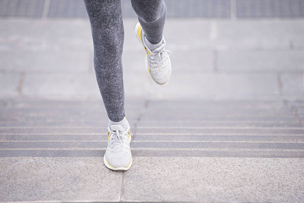 Speed strength training. Close up female runner feet. Woman exercising by using stairs. lance armstrong foundation stock pictures, royalty-free photos & images