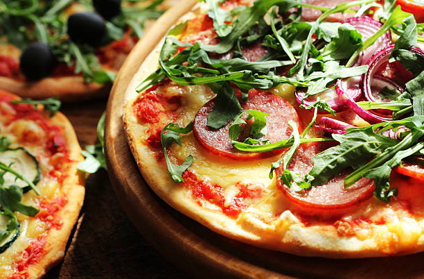 istock Different variations  of pizza.Pizza with sausage, zucchini, olives, rucola. 629692884