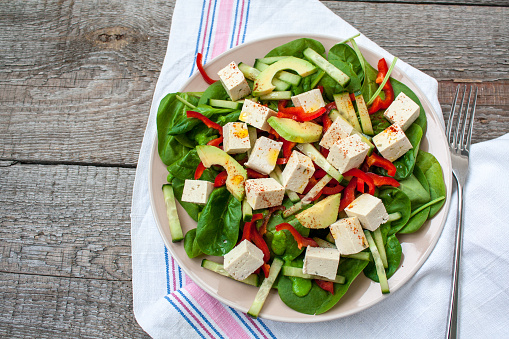 Green vegan salad with spinach and tofu. Love for a healthy raw food concept.