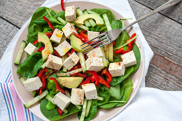 istock Green vegan salad with spinach and tofu 629693770