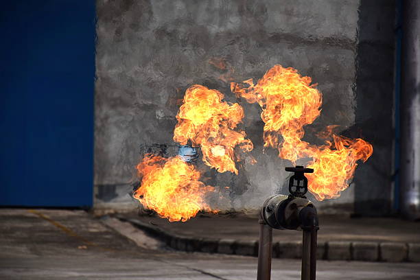 on fire with gas leak from pipe and valv. - clock time alarm clock urgency imagens e fotografias de stock