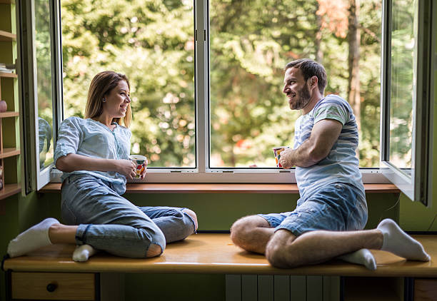 istock Young happy couple communicating by the window. 629705622