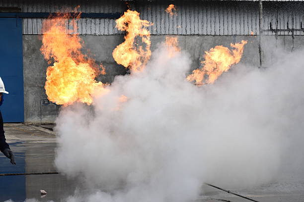 istock fire fighting with fire extingguishers and fire hose. 629706210
