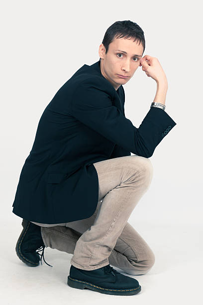 istock Handsome man doing different expressions in different sets of clothes: kneeling 629708842