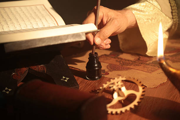 Detail Shot of an Old Islamic Scientist While Working Detail shot of an old and historic Islamic scientist is working in his studio writing, reading and exploring. old oil lamp stock pictures, royalty-free photos & images