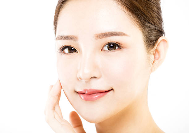 istock closeup   young  woman face isolated on white 629714310