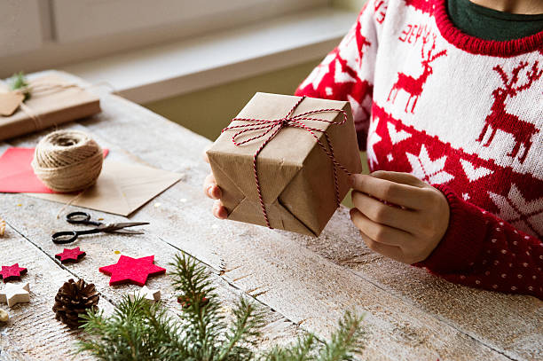 istock Unrecognizable woman wrapping and decorating Christmas present 629718136