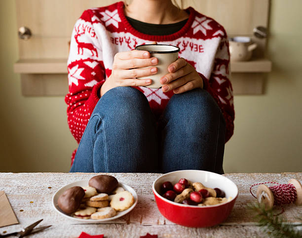 istock Unrecognizable woman with coffee cup, Christmas composition. 629718286
