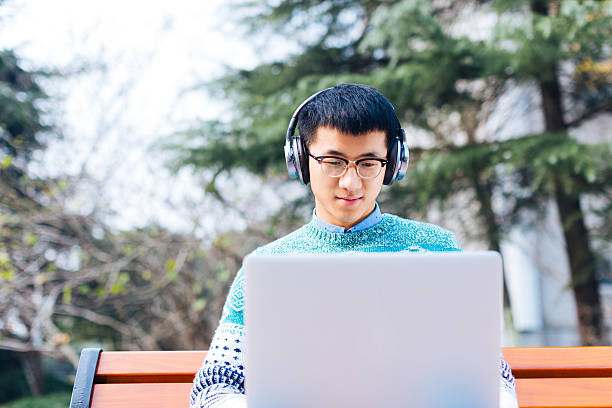 istock young asian man with laptop 629719054