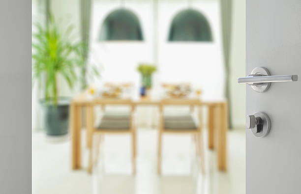 istock opened white door to wooden dining table and chairs 629719164