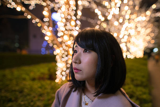istock Young woman looking at Christmas lights 629721250