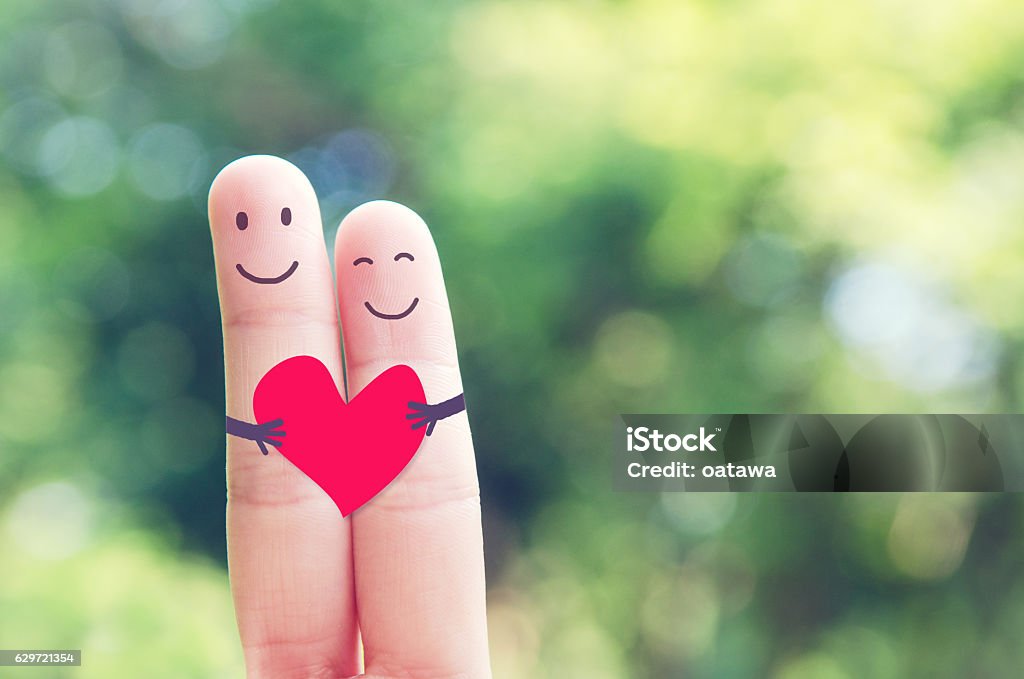Happy loving fingers holding red heart A happy couple in love with red heart in outdoor nature, Valentines day Love - Emotion Stock Photo