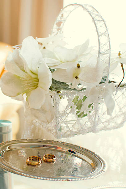 istock Wedding rings on flowers background 629721706