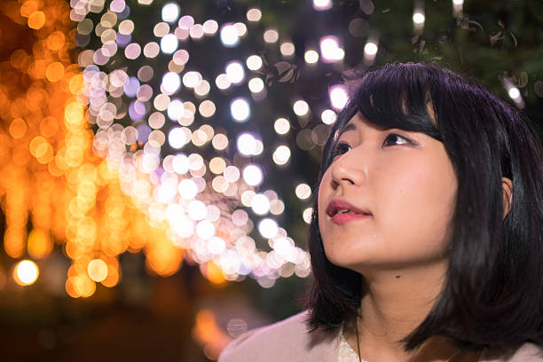 istock Young woman looking at Christmas lights 629722230