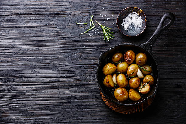 istock Fried potatoes in pan on wooden background copy space 629723556