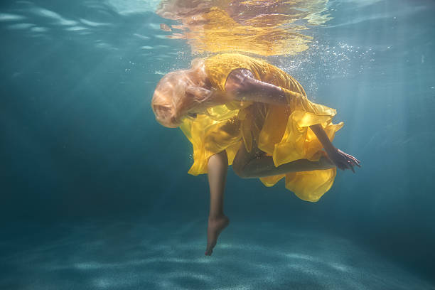 istock Woman underwater shows figures. 629724668