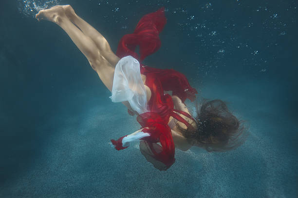 istock Woman in red dress underwater. 629725232
