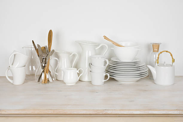istock Set of various white dishware and cutlery on wooden table 629725256