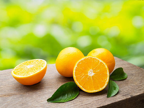 istock Fresh orange fruit group on wooden table of natural background 629726064
