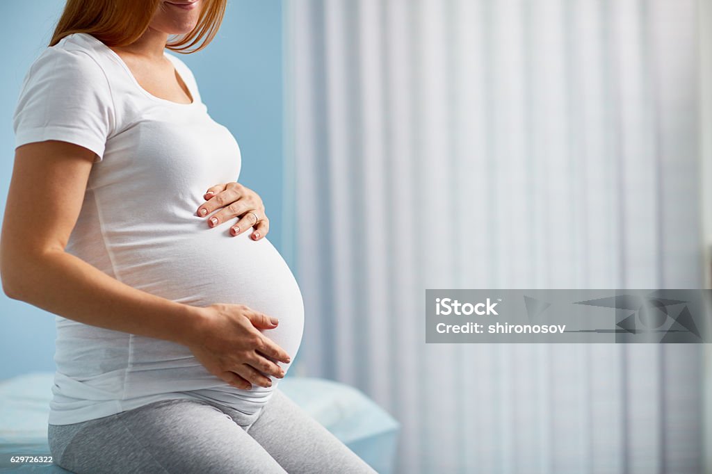 Expecting baby Pregnant woman sitting in childbearing center Pregnant Stock Photo