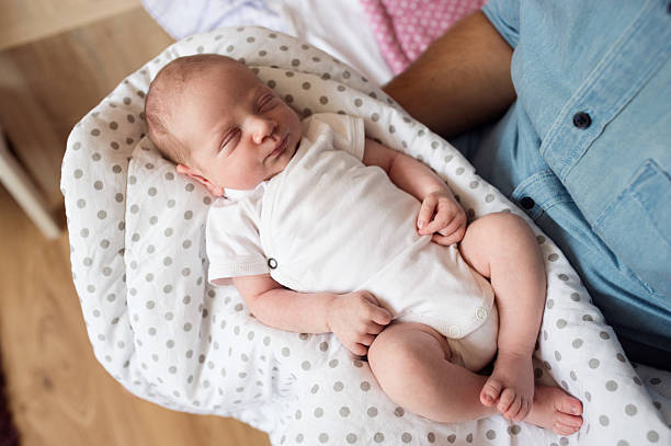 istock Unrecognizable father with newborn baby son, legs and hand 629735496