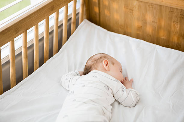 istock Baby boy sleeping on a cradle 629737938