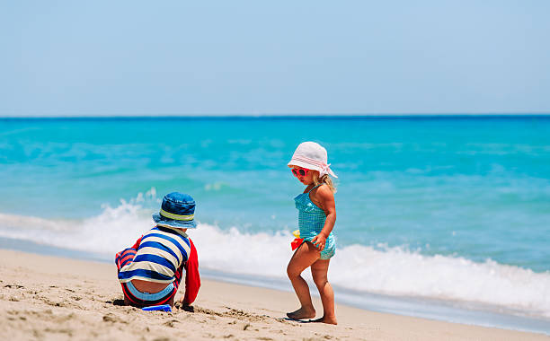 istock kids play with sand on summer beach 629738490